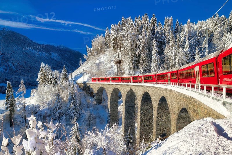 Rhaetian railway on viaduct in winter landscape, near Filisur, Canton Graubünden, Switzerland, Europe