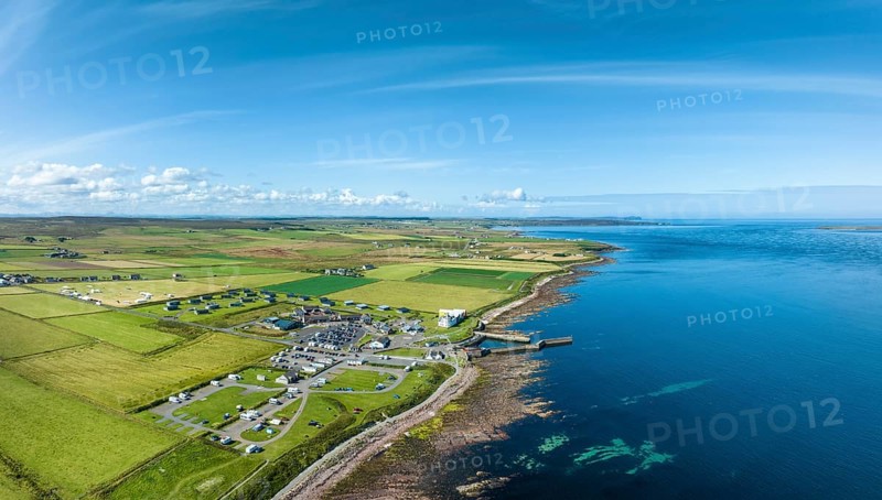 Aerial panorama of the village of John o' Groats, the north-easternmost point of Great Britain with campsite, tourist centre and holiday village, County Caithness, Scotland, Great Britain