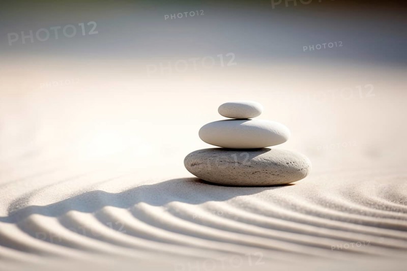 Zen stones stack on raked sand in a minimalist setting for balance and harmony. Balance, harmony, and peace of mind, wellness, meditation, and spirituality concept, AI generated
