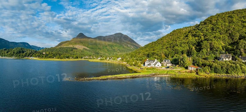 Aerial panorama of the freshwater loch Loch Leven with the former Pier House in the village of Glen Coe, above it the 742 metre high Pap of Glencoe, Highlands, Scotland, United Kingdom, Europe