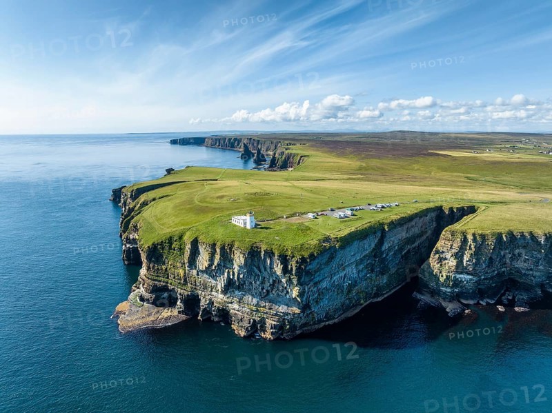 Aerial view of the rugged coastal landscape at Duncansby Head with the lighthouse and the Duncansby Stacks rock formation behind, Scotland's north-eastern point, County Caithness, Scotland, United Kingdom, Europe