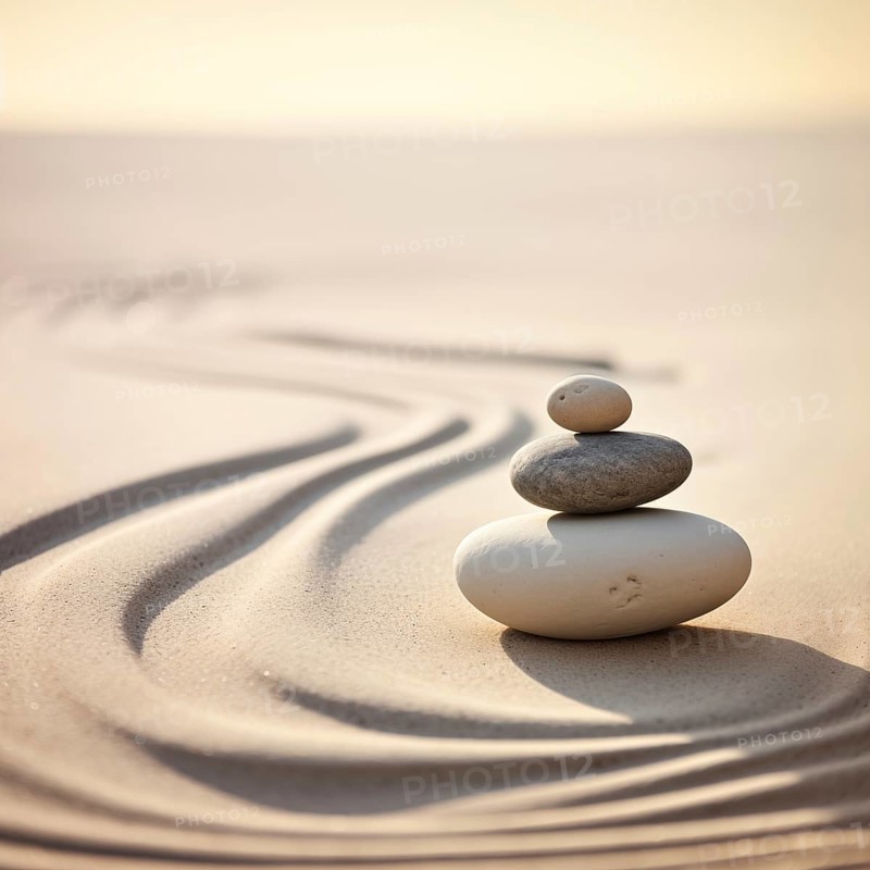 Zen stones stack on raked sand waves in a minimalist setting for balance and harmony. Balance, harmony, and peace of mind, wellness, meditation, and spirituality concept, AI generated