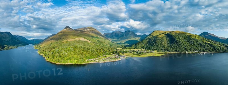 Aerial panorama of the freshwater loch Loch Leven with the village of Glen Coe, above it the 742 metre high Pap of Glencoe, Highlands, Scotland, United Kingdom, Europe