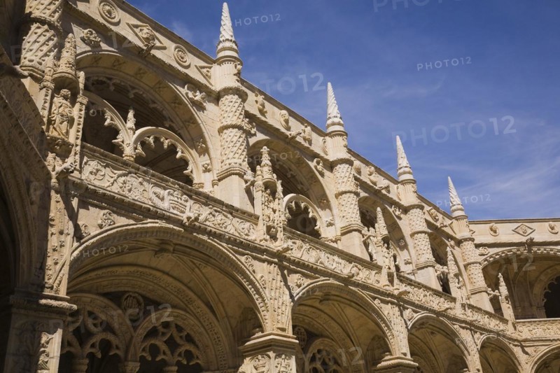 Old architectural building with arches and carved decorative sculptures in the inner courtyard at Jeronimos Monastery, Lisbon, Portugal, Europe