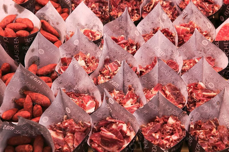Cuts of ham and small sausages packed for sale, Mercado San Miguel market, Madrid city centre, Spain, Europe