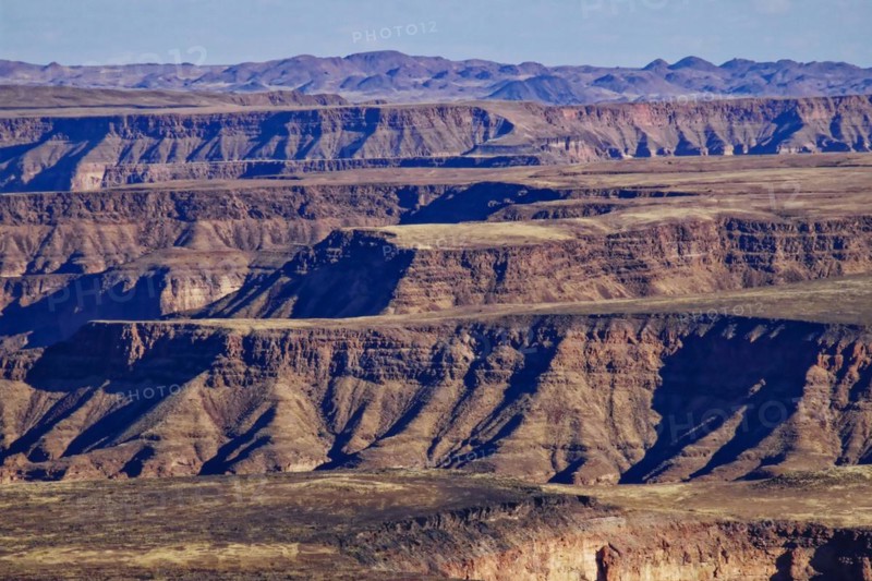 Table mountains above the Fish River Canyon. The Fish River Canyon is part of the state-owned Ais-Ais Richtersveld Transfontier Park. The Hunsberg Mountains in the background. Karas region, southern Namibia