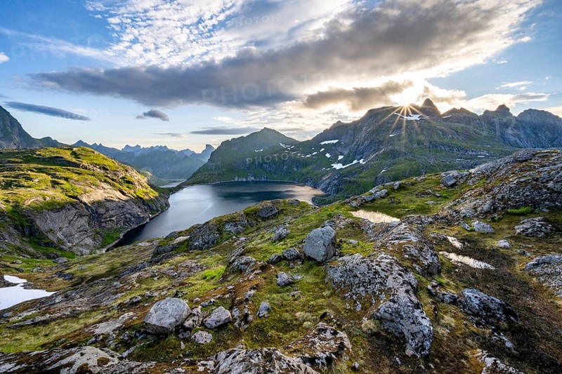 Mountain landscape with lake Tennesvatnet, at sunrise with sun star, Moskenesoya, Lofoten, Nordland, Norway, Europe