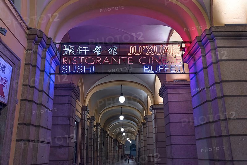 Nocturnal illuminated advertising in the historic arcade at the harbour, Genoa, Italy, Europe