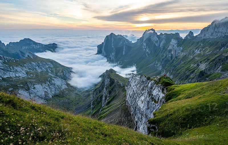View over SÃ¤ntis mountains into the valley of Meglisalp at sunrise, Rotsteinpass, high fog in the valley, SÃ¤ntis, Appenzell Ausserrhoden, Appenzell Alps, Switzerland, Europe