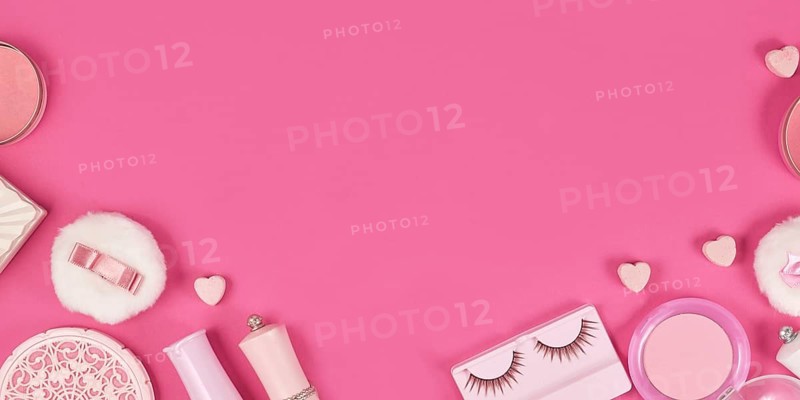 Banner with cute pink makeup beauty products like brushes, powder or lipstick on sides of pink background with empty copy space in middle
