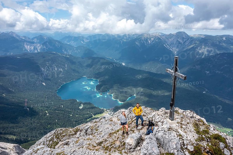 Aerial view, hiker at the summit cross of the Waxenstein, Eibsee lake and Wetterstein mountains, Garmisch-Patenkirchen, Bavaria, Germany, Europe