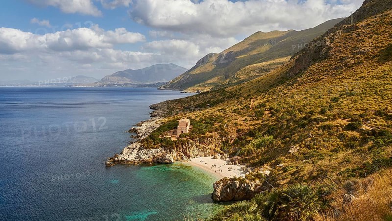 Cloudy weather, coastline, green coastal mountains, small bay, pebble beach, bathers, Zingaro, national park, nature reserve, northwest, Sicily, Italy, Europe