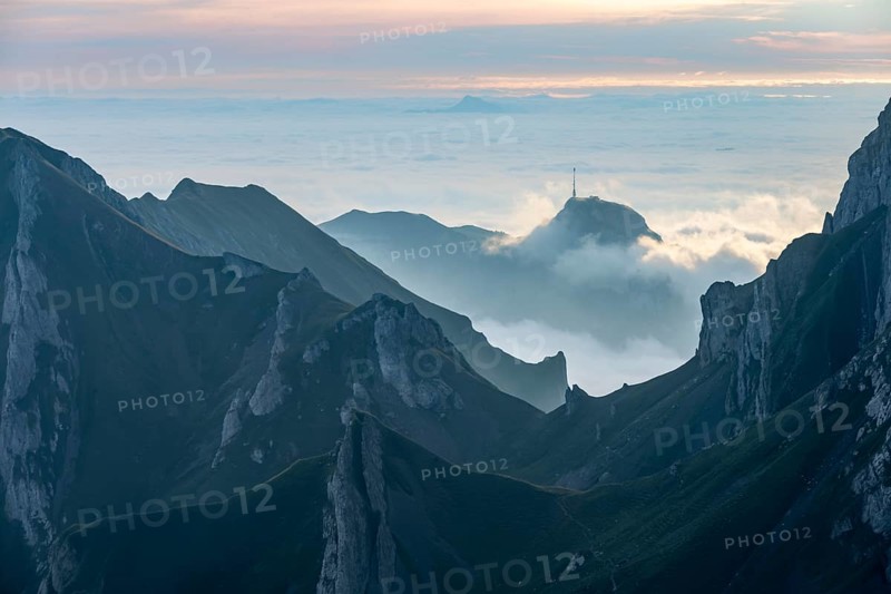 Sunrise over ridge in Alpstein, high fog in valley, SÃ¤ntis, Appenzell Ausserrhoden, Appenzell Alps, Switzerland, Europe