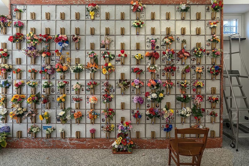 Urn graves with floral decorations in a hall at the Monumental Cemetery, Cimitero monumentale di Staglieno), Genoa, Italy, Europe