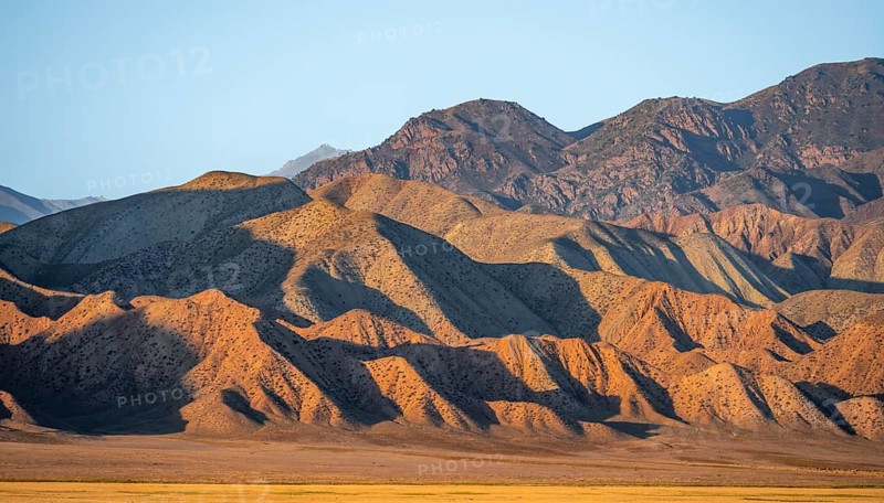 Dry mountains in the evening light, Toktogul reservoir, Jalalabad region, Kyrgyzstan, Asia