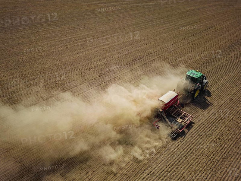 A tractor with a Horsch PRONTO DC 6 seed drill sowing in a dry field in late summer., Doma, Saxony, Germany, Europe