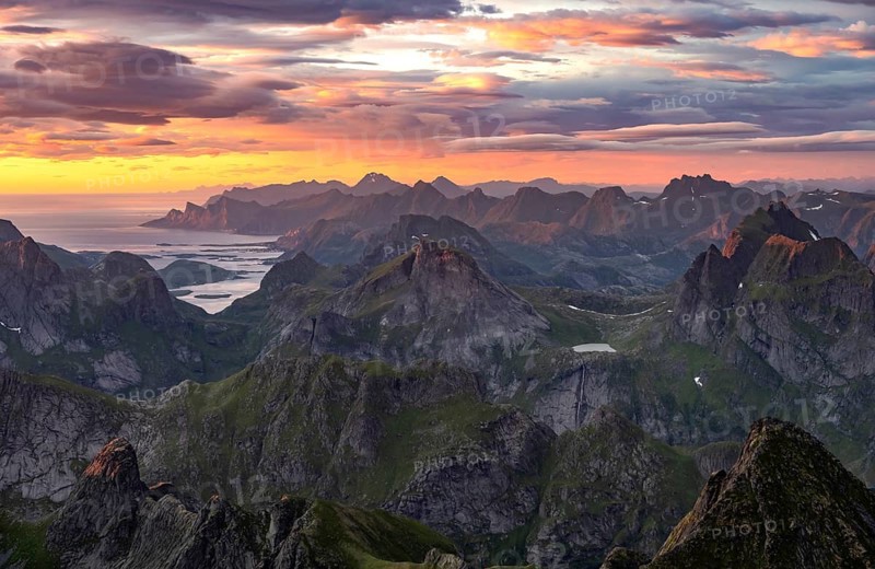 View over mountain top and sea, dramatic sunset, from the top of Hermannsdalstinden, Moskenesöy, Lofoten, Nordland, Norway, Europe