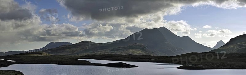 Highland scenery with loch and rain clouds at Assynt, Sutherland, Scotland, UK