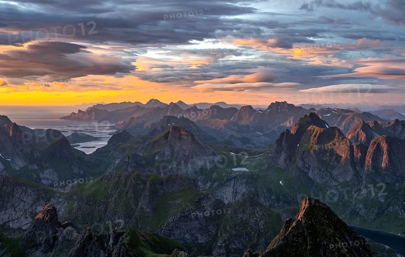 View over mountain top and sea, dramatic sunset, from the top of Hermannsdalstinden, Moskenesöy, Lofoten, Nordland, Norway, Europe