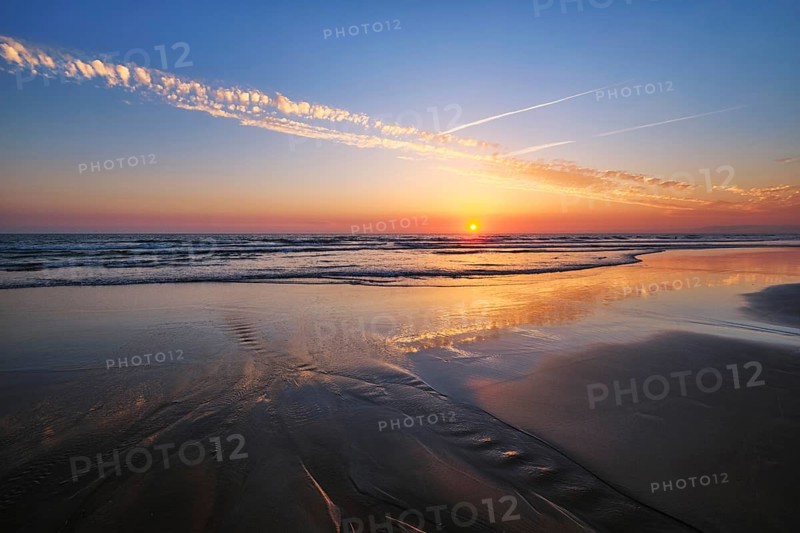 Atlantic ocean sunset with surging waves at Fonte da Telha beach, Costa da Caparica, Portugal, Europe