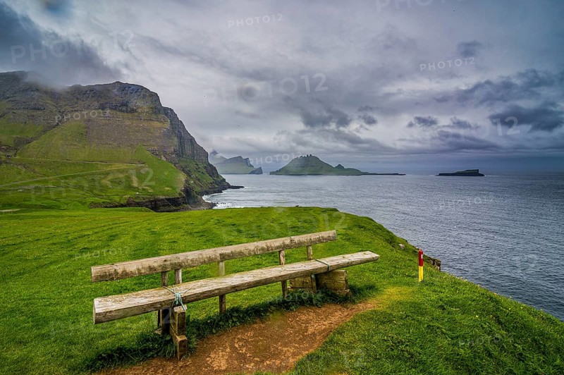Bench overlooking over Gasadalur, Vagar, Faroe islands, Denmark, Europe