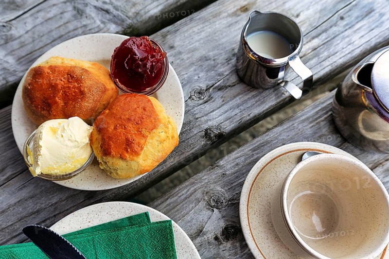 Cornish cream tea in the garden café, speciality, typical afternoon meal, scones, clotted cream, strawberry jam, tea with milk, Cornwall, South England, England, Great Britain