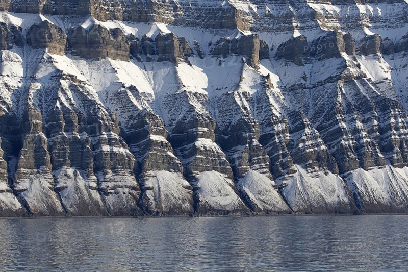 Snow covered Carboniferous mountain slope showing strata in autumn, Billefjord, Billefjorden, Svalbard, Spitsbergen, Norway, Europe