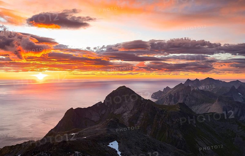 View over mountain top and sea, dramatic sunset, from the top of Hermannsdalstinden, Moskenesöy, Lofoten, Nordland, Norway, Europe