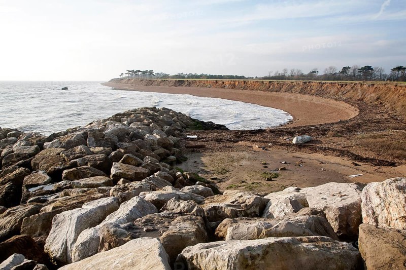 Rock armour boulders used as coastal defence against rapid erosion at East Lane, Bawdsey, Suffolk, England, UK