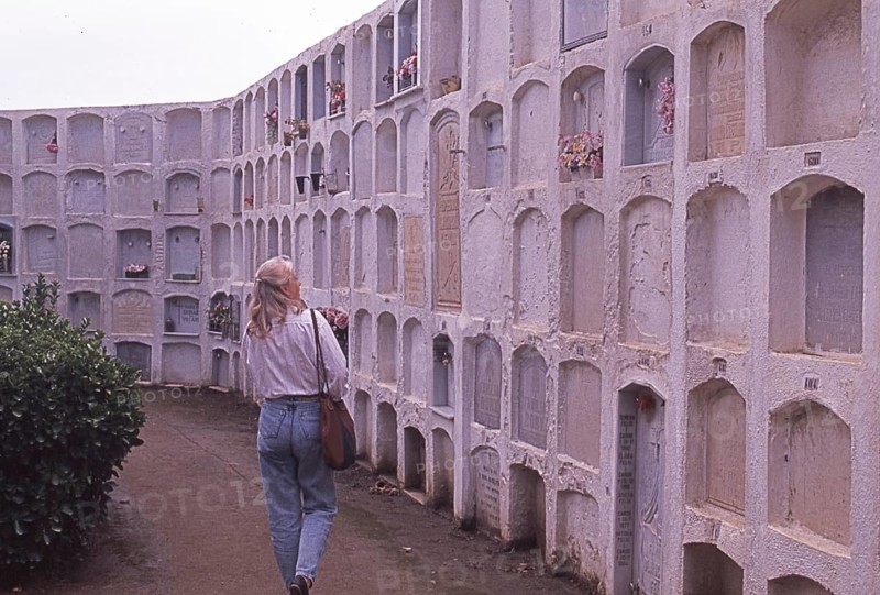 Woman visits burial site in Calella, Costa Brava, Barselona, â€‹â€‹Catalonia, Spain, Southern Europe. Scanned thumbnail slide, vintage, retro, funny, Europe