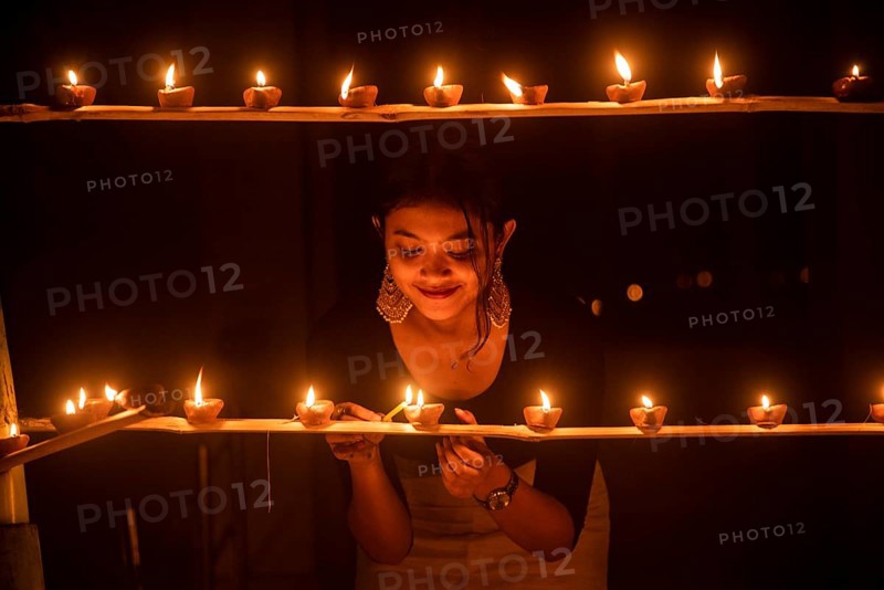 Students of Cotton University lighting diya (Clay lamp) on the occasion of Diwali Festival, on November 04, 2021 in Guwahati, India. During Diwali, people exchanging gifts, spending time with loved ones, families gather to pray for prosperity and rid the darkness and evil forces with display of lights