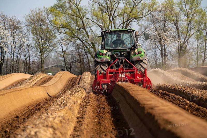 A farmer builds asparagus ridges on a field with the help of an asparagus tiller, in which the asparagus then grows, Dormagen, North Rhine-Westphalia, Germany, Europe