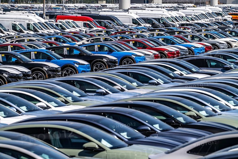 Storage area for new cars in the port of Vlissingen-Oost, vehicles are temporarily stored on over 100 hectares to ship them from Europe to the United Kingdom, Ford cars, others such as models from the Chinese car manufacturer BYD are delivered from here in Europe, wind farm, Netherlands
