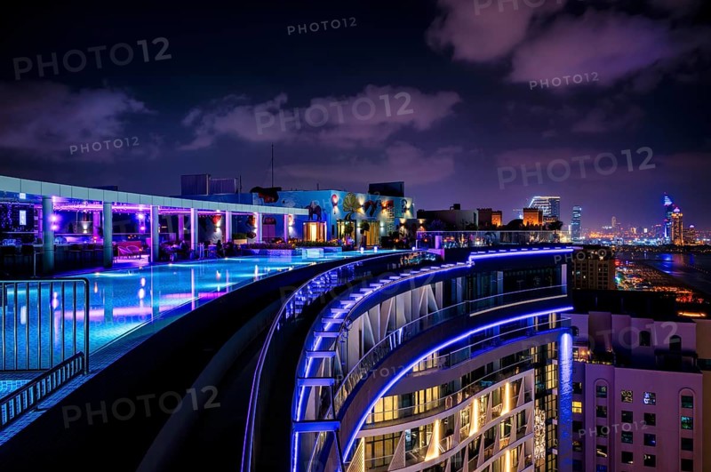 Night shot rooftop pool, swimming pool, Dubai Marina skyline behind, Hotel NH Collection The Palm Jumeirah, Dubai, United Arab Emirates, VAR, Asia
