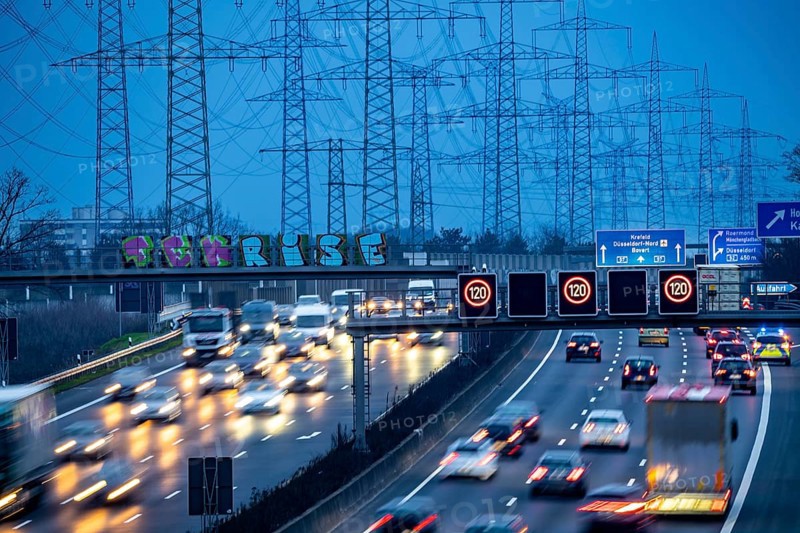 A57 motorway near Kaarst in the Rhine district of Neuss, view in the direction of the Kaarst motorway junction, heavy evening traffic, overhead power lines, along the motorway, North Rhine-Westphalia, Germany, Europe