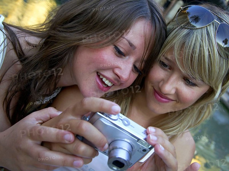 Two woman taking a selfie with the camera, Barcelona, Spain, Europe