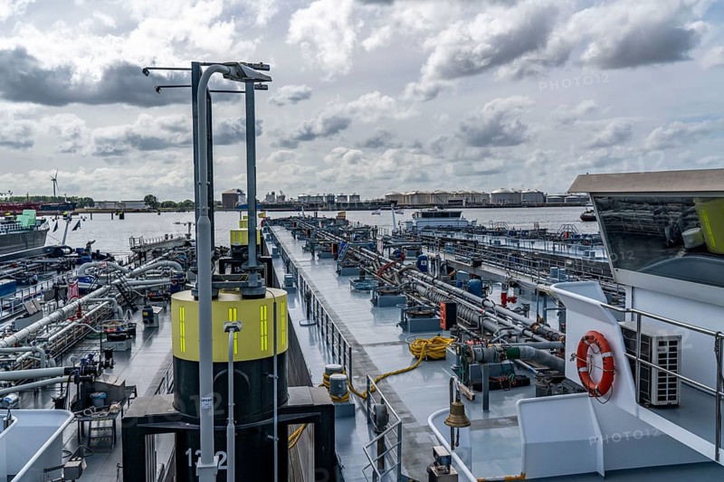 Petroleum harbour, Vopak Terminal Europoort, crude oil tank farm, over 99 large tanks, and 22 loading terminals for overseas and inland vessels, inland tankers waiting to be loaded, Europoort Port of Rotterdam, Netherlands