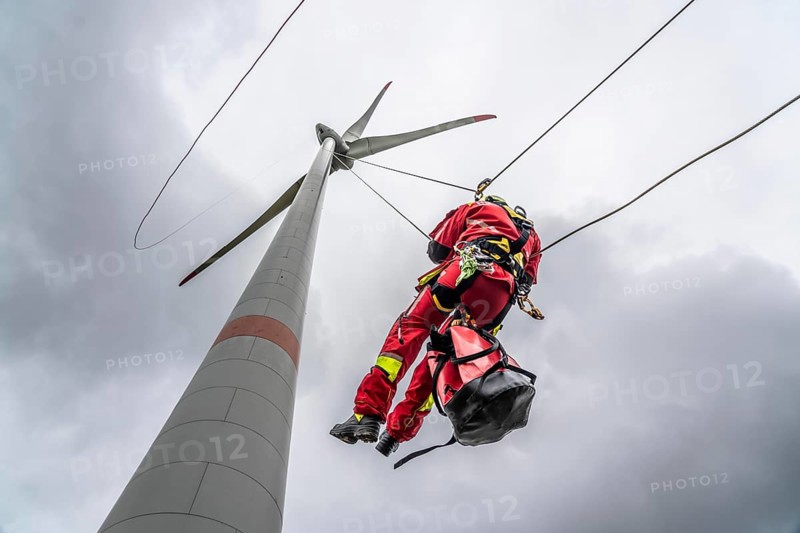 Height rescuers from the Oberhausen fire brigade practise abseiling from a wind turbine from a height of 150 metres after rescuing an accident victim from the nacelle, Issum, North Rhine-Westphalia, Germany, Europe