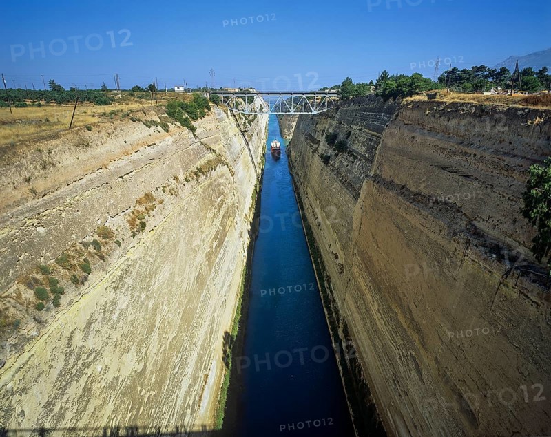 A cargo ship travels through a canal-like waterway with steep, dry walls, Corinth Canal, Corinth, Peloponnese, Greece, Europe