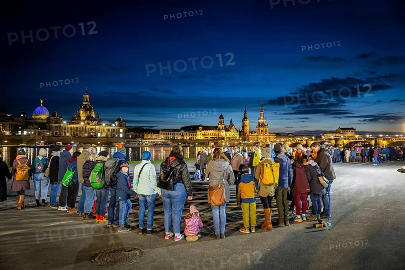 On 13 and 14 February 1945, Dresden was heavily destroyed in three Allied bombing raids. Every year, the people of Dresden commemorate this event at various events. A long human chain symbolised the protection of the city centre. Here looking from the Königsufer across the Elbe to the Old Town, Dresden, Saxony, Germany, Europe