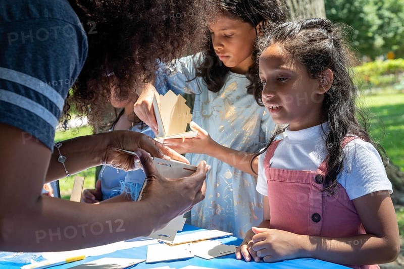 Detroit, Michigan, Children learn how to put together birdhouses that they can then paint at the annual 'Summer Sizzler' picnic and party held by two Detroit Neighborhoods, Morningside and East English Village