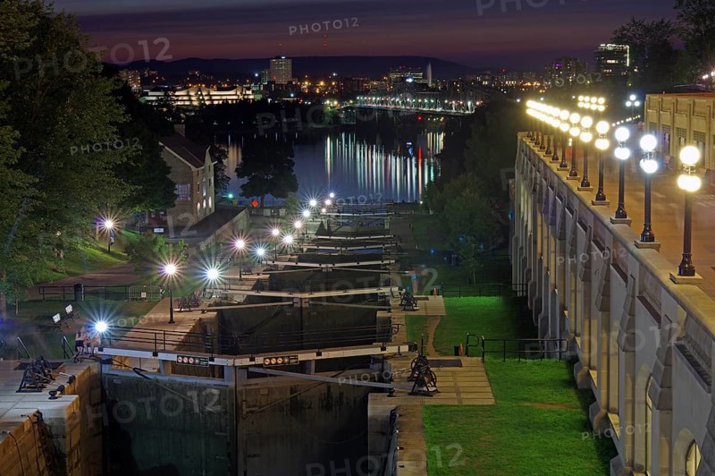 Night scene of a city on a river with illuminated locks and buildings, Rideau Canal, Ottawa, Ontario, Canada, North America