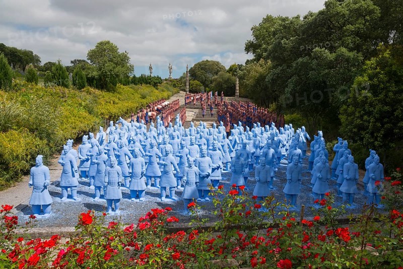 Numerous blue terracotta soldier statues stand on a path lined with flowers and trees, Bacalhôa, Bacalhoa Buddha Eden, Quinta dos Loridos, largest oriental garden in Europe, Bombarral, Oeste, Centro, Portugal, Europe