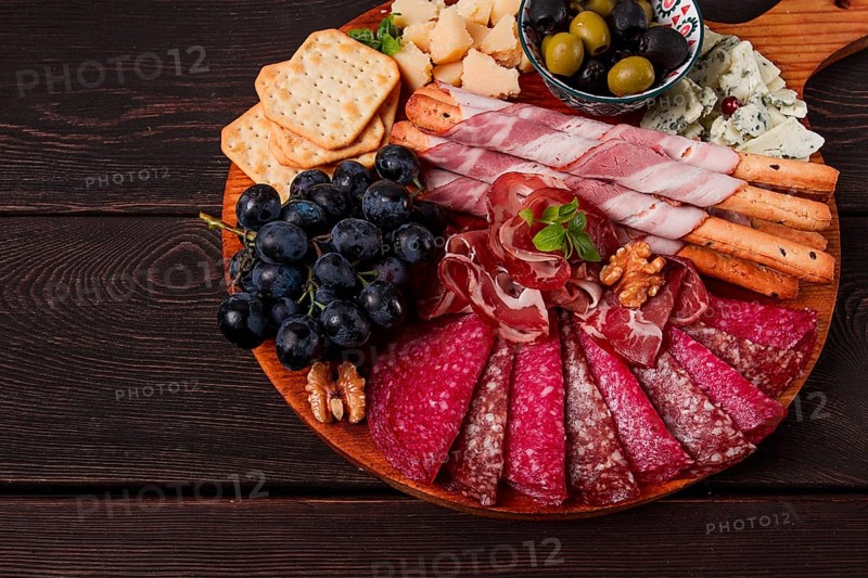 Appetizer, assortment, set, sausage, and cheese, on a wooden board, top view, no people
