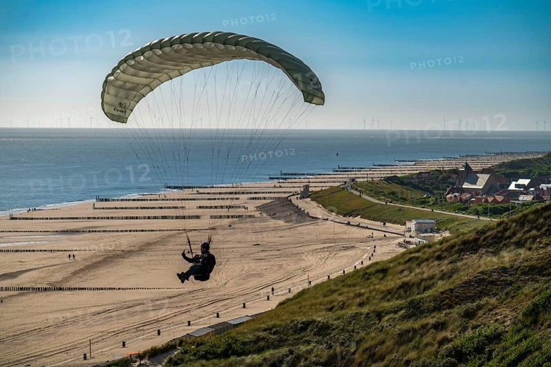 Paragliders along the dunes of Zoutelande, in Zeeland, South Holland, Netherlands