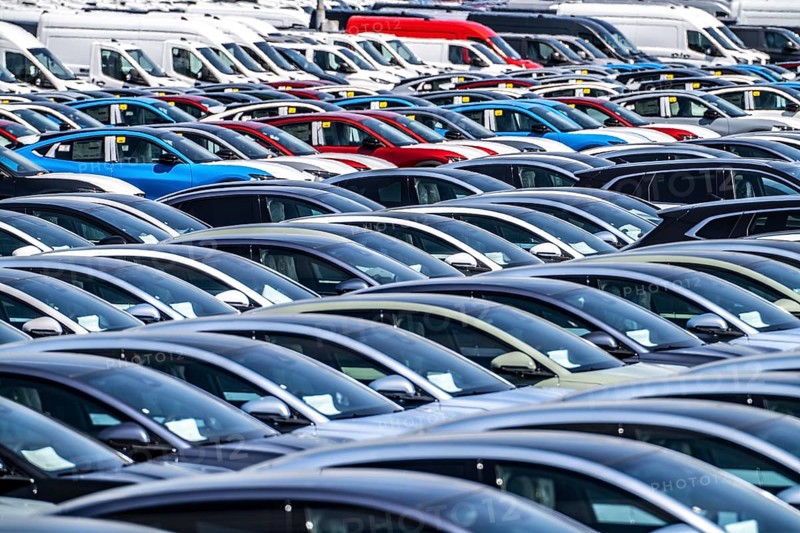 Storage area for new cars in the port of Vlissingen-Oost, vehicles are temporarily stored on over 100 hectares to ship them from Europe to the United Kingdom, Ford cars, others such as models from the Chinese car manufacturer BYD are delivered from here in Europe, wind farm, Netherlands