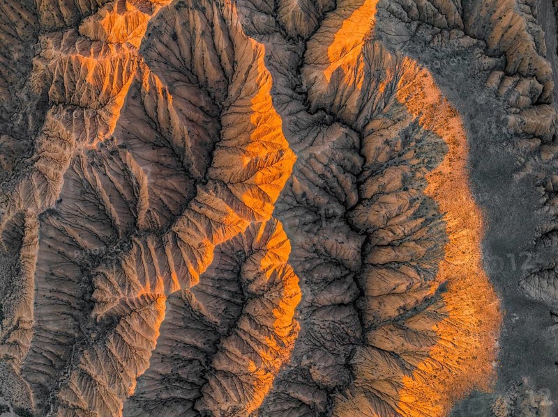 Landscape of eroded hills at Lake Issyk Kul, top-down, badlands at sunrise, aerial view, Canyon of the Forgotten Rivers, Issyk Kul, Kyrgyzstan, Asia
