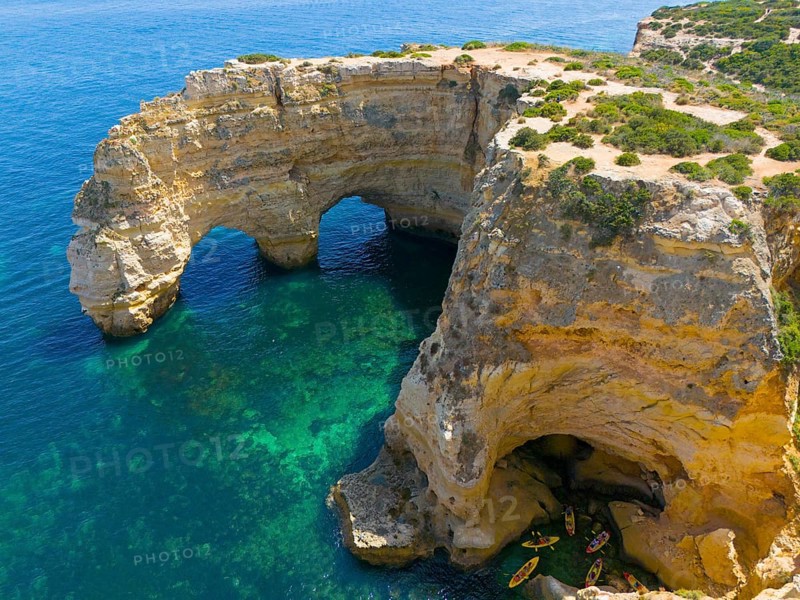 Large rock formations with natural arches on the coast, near water with canoes, aerial view, Praia da Marinha, double rock arch, Lagoa, Rocky Algarve, Algarve, Portugal, Europe