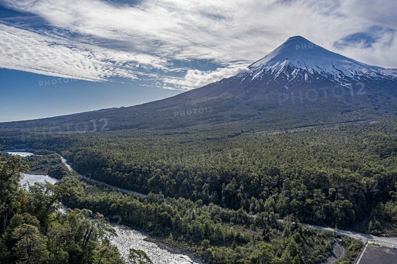 Snow-capped volcano Osorno rising high above river Rio Petrohue, early spring, chilenean lake district, Los Lagos Region, Chile, South America