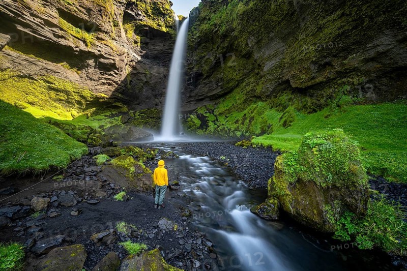 Tourist at Kvernufoss waterfall, in summer when the weather is nice, gorge and river, long exposure, Skogar, Sudurland, South Iceland, Iceland, Europe
